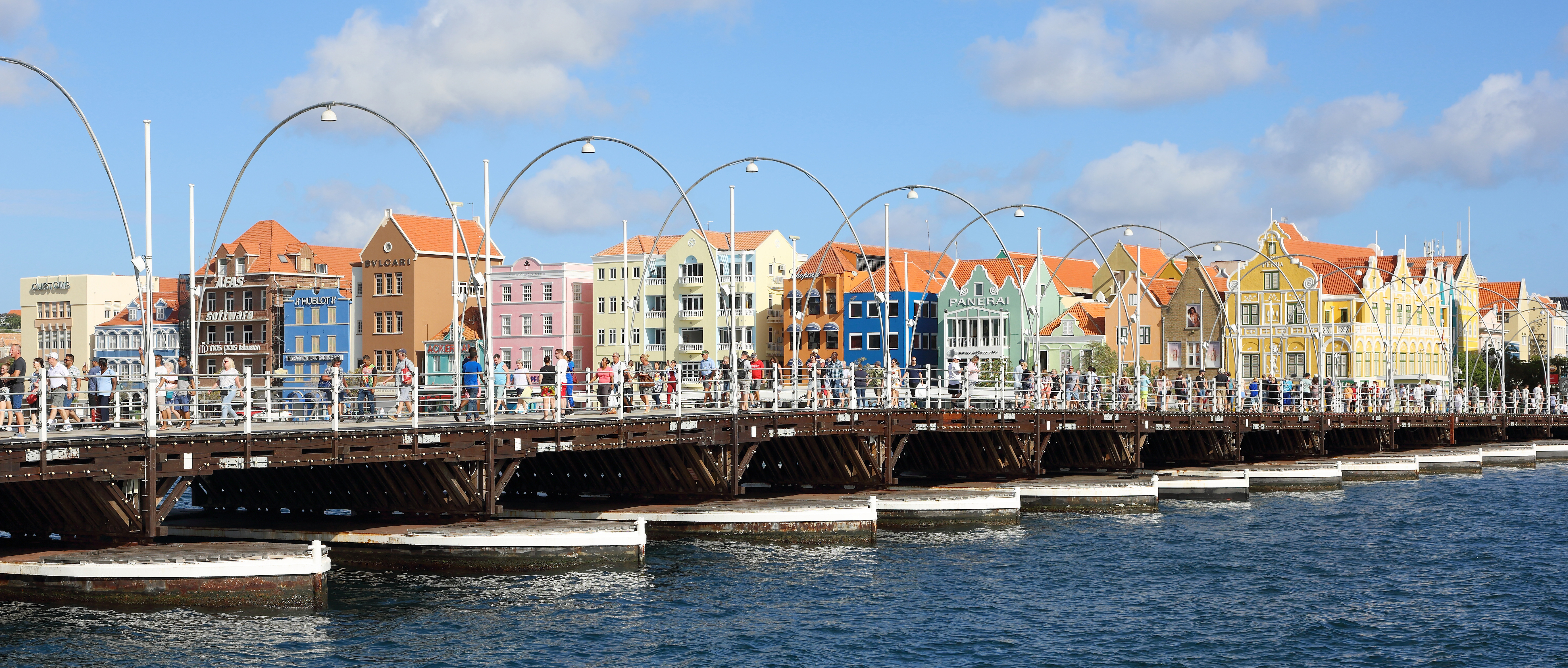 Colorful waterfront buildings and Queen Emma Bridge in Willemstad, Curacao.